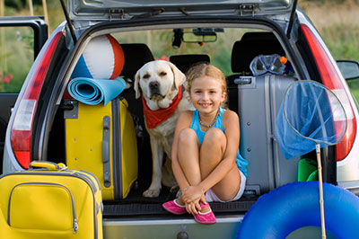Child with dog in car
